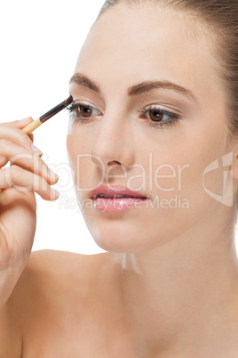 doing the makeup brown eyeshadow on beautiful eyes