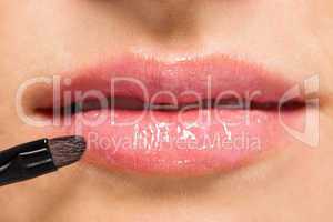 woman applying lipstick on lips natural beauty