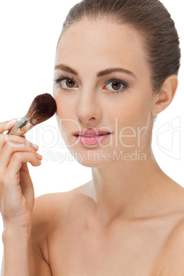 apllying powder make up on face portrait