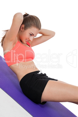 young attractive woman doing sit ups in sportswear isolated
