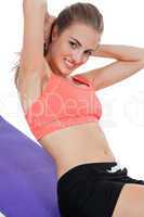 young attractive woman doing sit ups in sportswear isolated