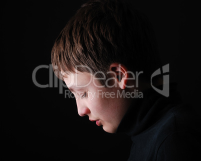 Profile of the upset teenage boy