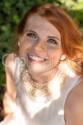 beautiful smiling young redhead woman portrait outdoor