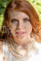 beautiful smiling young redhead woman portrait outdoor