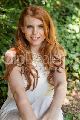 beautiful smiling young redhead woman portrait outdoor