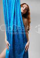 Nude woman behind the shiny cloth