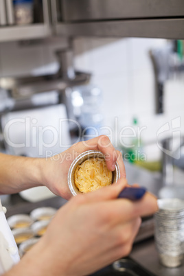 Chef preparing desserts removing them from moulds