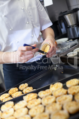 Chef preparing desserts removing them from moulds