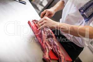 Chef or butcher dicing meat