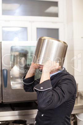 Chef cooking a vegetables stir fry over a hob