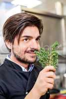 Chef checking the freshness of a bunch of herbs