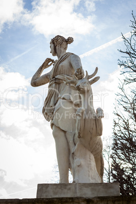 Bird perched on an ancient stone statue