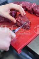 Chef or butcher dicing meat