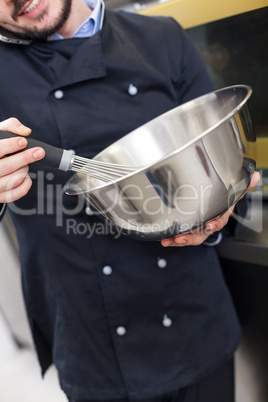 Chef cooking a vegetables stir fry over a hob