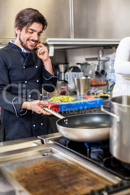 Chef taking a call on his smartphone