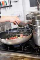Chef or braising meat in a frying pan