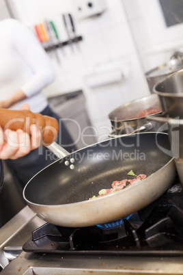 Chef or braising meat in a frying pan