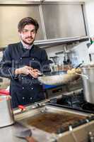 Chef cooking a vegetables stir fry over a hob