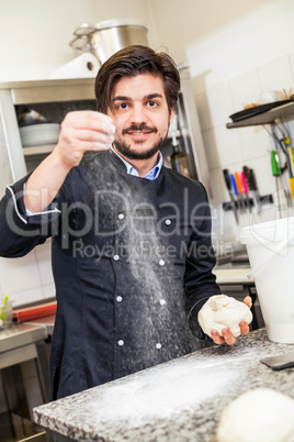 Chef tossing dough while making pastries