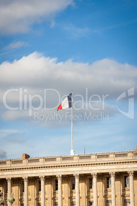 Flag of France fluttering under a serene blue sky