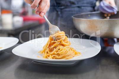 Chef plating up seafood pasta