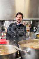 Chef cooking a vegetables stir fry over a hob