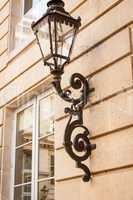 Old wrought iron lamp on a building exterior