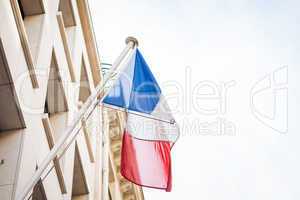 Flag of France fluttering under a serene blue sky