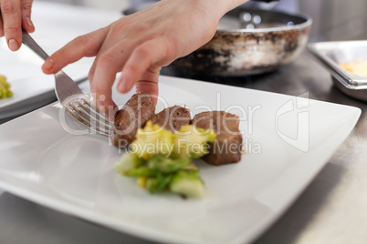 Chef plating up food in a restaurant