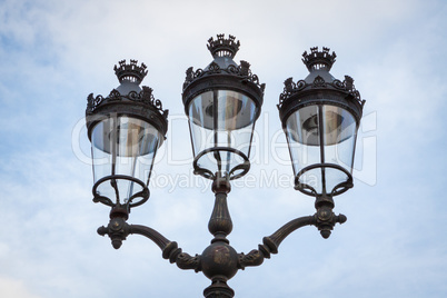 Old wrought iron lamp on a building exterior