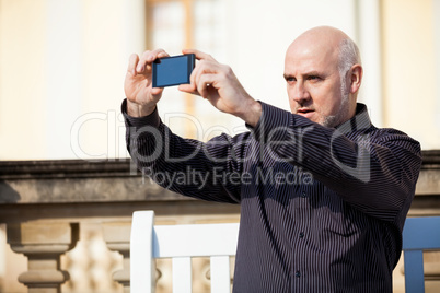 Man taking a photograph with his mobile