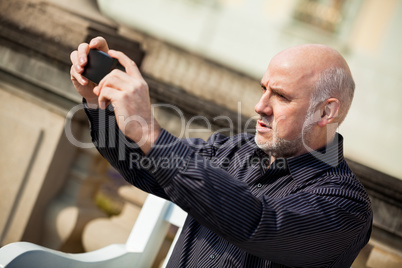Man taking a photograph with his mobile
