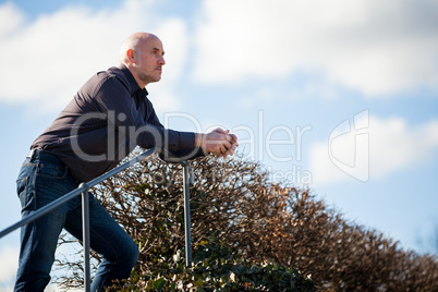 Thoughtful man sitting on a flight of steps