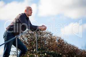 Thoughtful man sitting on a flight of steps