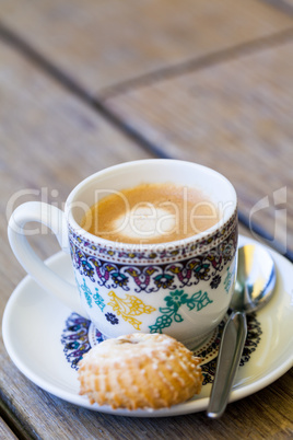 Cup of freshly brewed tea and a cookie