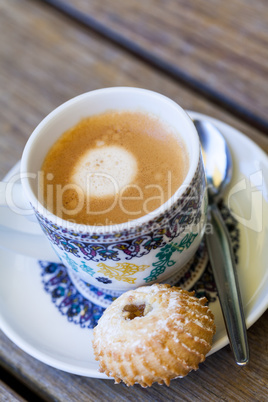 Cup of freshly brewed tea and a cookie