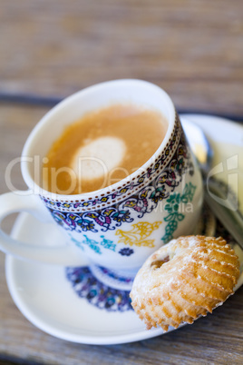 Cup of freshly brewed tea and a cookie