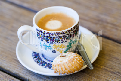 Cup of freshly brewed tea and a cookie