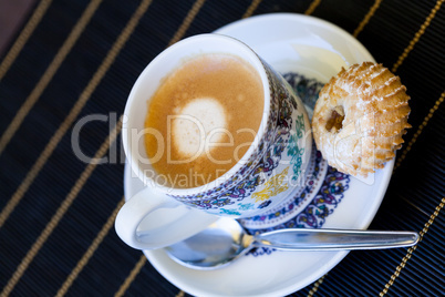 Cup of freshly brewed tea and a cookie