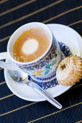 Cup of freshly brewed tea and a cookie