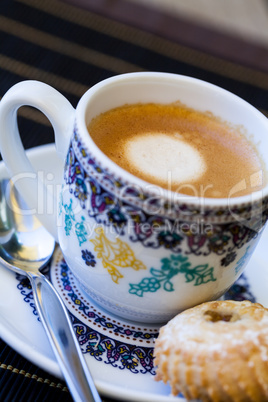 Cup of freshly brewed tea and a cookie