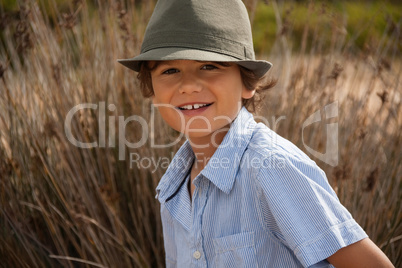 cute little boy playing in sand on beach in summer