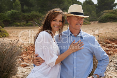 happy adult couple in summertime on beach