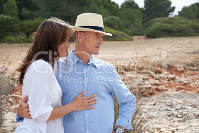 happy adult couple in summertime on beach