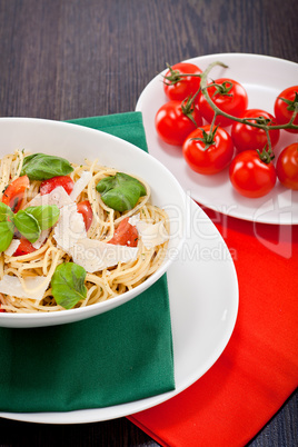 fresh tasty pasta spaghetti with tomatoes and basil