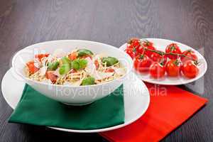 fresh tasty pasta spaghetti with tomatoes and basil