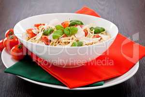 fresh tasty pasta spaghetti with tomatoes and basil