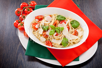 fresh tasty pasta spaghetti with tomatoes and basil