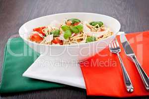 fresh tasty pasta spaghetti with tomatoes and basil