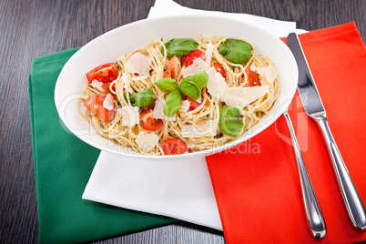 fresh tasty pasta spaghetti with tomatoes and basil